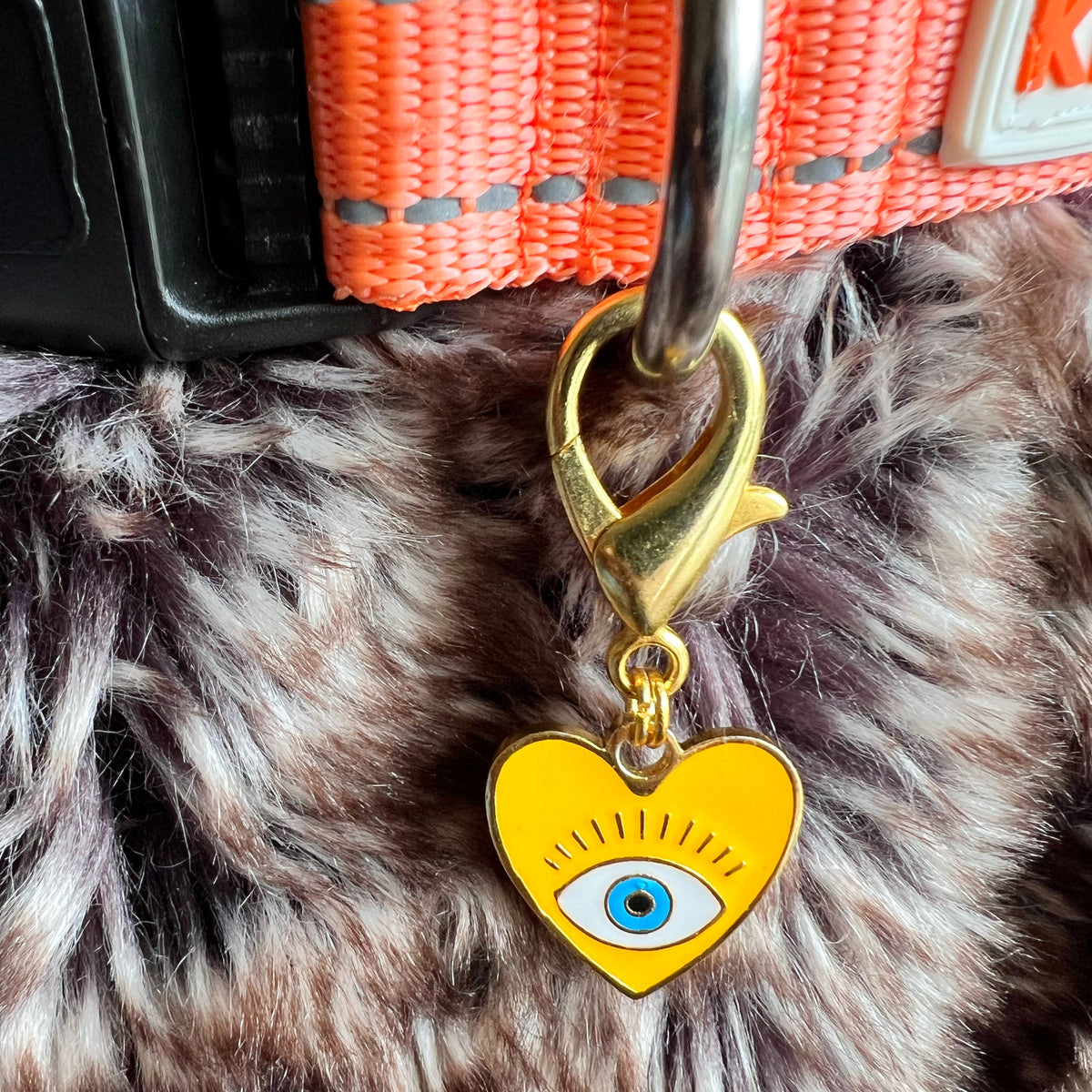 Yellow Heart Nazar Pet Charm in 22k gold plating clipped to a pet collar