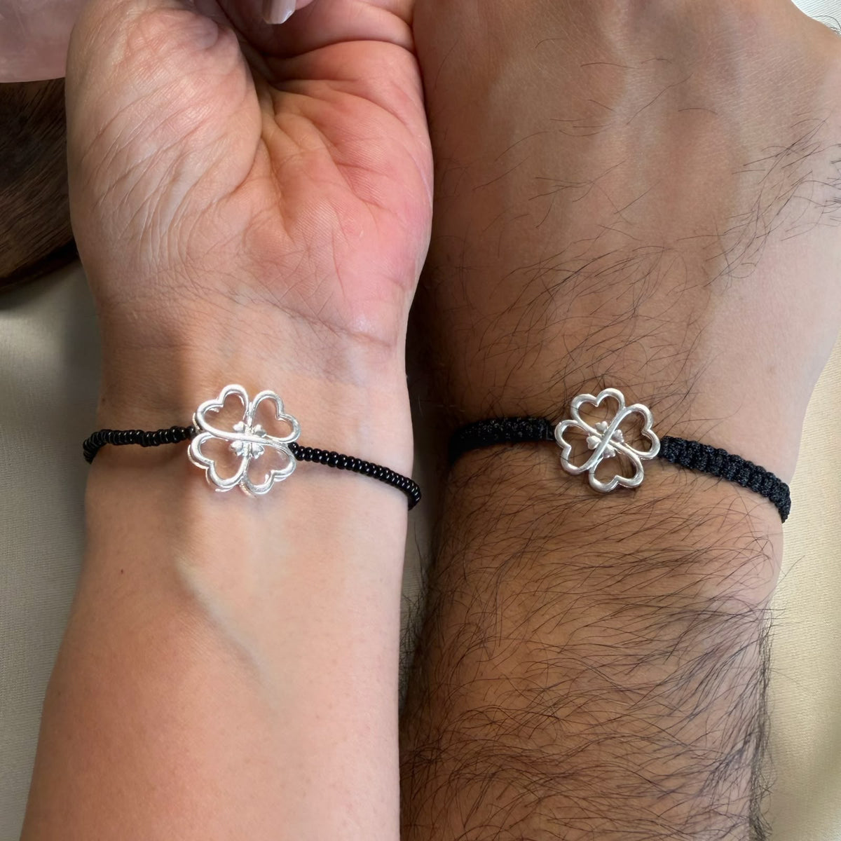 Couple Lucky Clover silver bracelets worn together, Amaltaas
