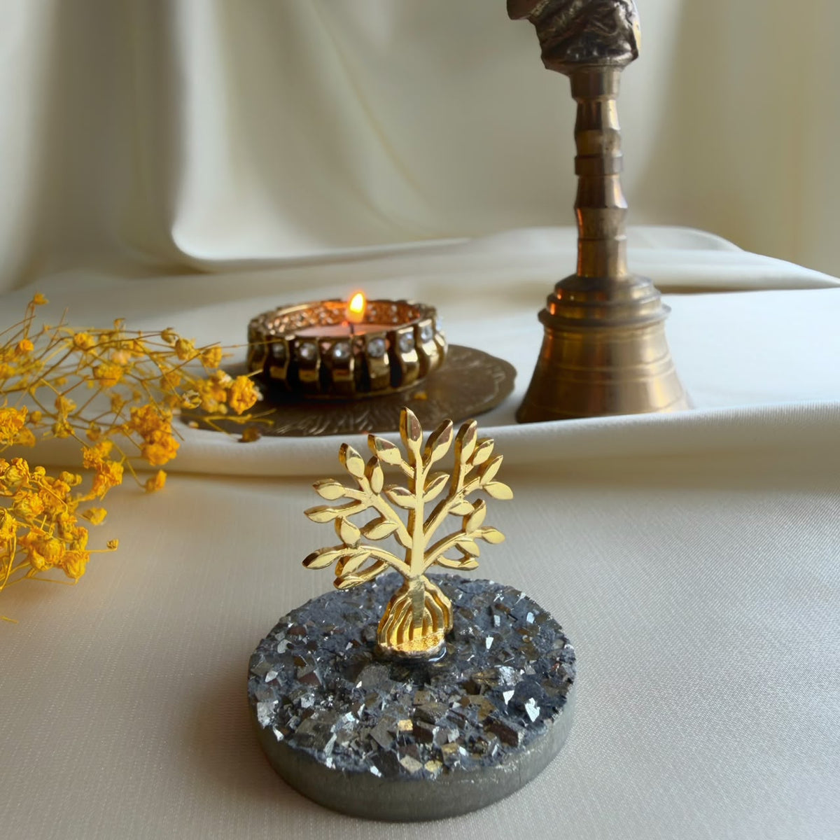 Tree of Life gold-plated motif on pyrite gemstone with diya and brass bell
